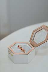 white wooden box with gold wedding rings