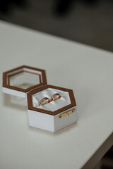 white wooden box with gold wedding rings