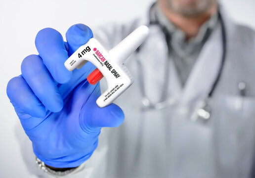 Doctor holds Naloxone spray in hand. Food and Drug Administration approved spray form of Naloxone.
