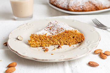 Sweet carrot cake slice on vintage plate. Vegan recipe.  Piece of homemade carrot cake with almond
