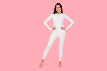 Woman in warm thermal underwear on pink background