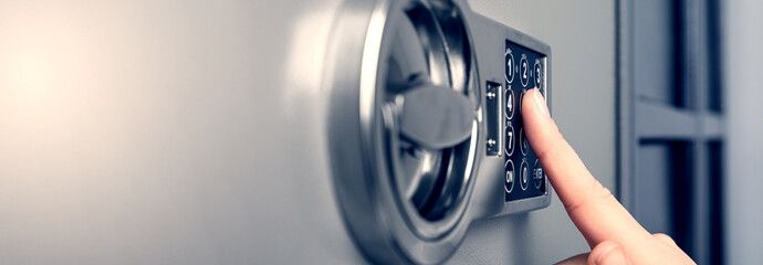 Woman opening steel safe with electronic lock, closeup. Banner design - obrazy, fototapety, plakaty