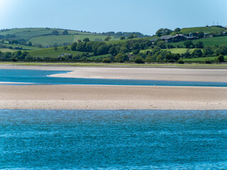 A sandbank at low tide, spring. The sea water is a beautiful turquoise color. Sea coast, landscape.