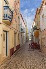 Narrow street leading to the beach in Nazaré, Portugal