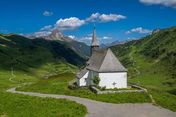 Fototapeta na wymiar St. Jakobus am Simmel Chapel on the Hochtannberg Pass with Biberkopf Mountain, State of Vorarlberg, Austria
