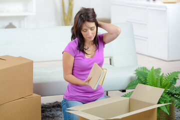 a woman is sorting out exs books