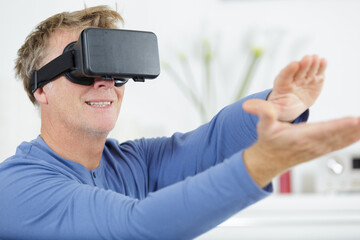 confident mature man wearing a vr viewer