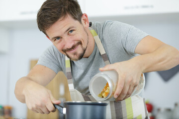 man cooking at home in kitchen