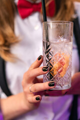 female person holding a cocktail glass