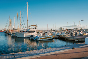 Fototapeta premium Small boats and yachts are anchored in the Port of Sant Carlos De La Rapita, Spain