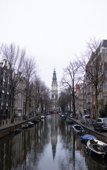 Fototapeta premium Groenburgwal Canal in Amsterdam. There is beautiful Zuiderkerk tower in the background.