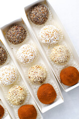 Assorted vegan sweets, Delicious Candy Balls with seeds, dried fruit and cocoa powder, Healthy Candies