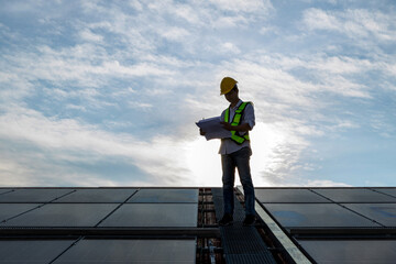 Engineer working setup Solar panel at the roof top. Engineer or worker work on solar panels or solar cells on the roof of business building	