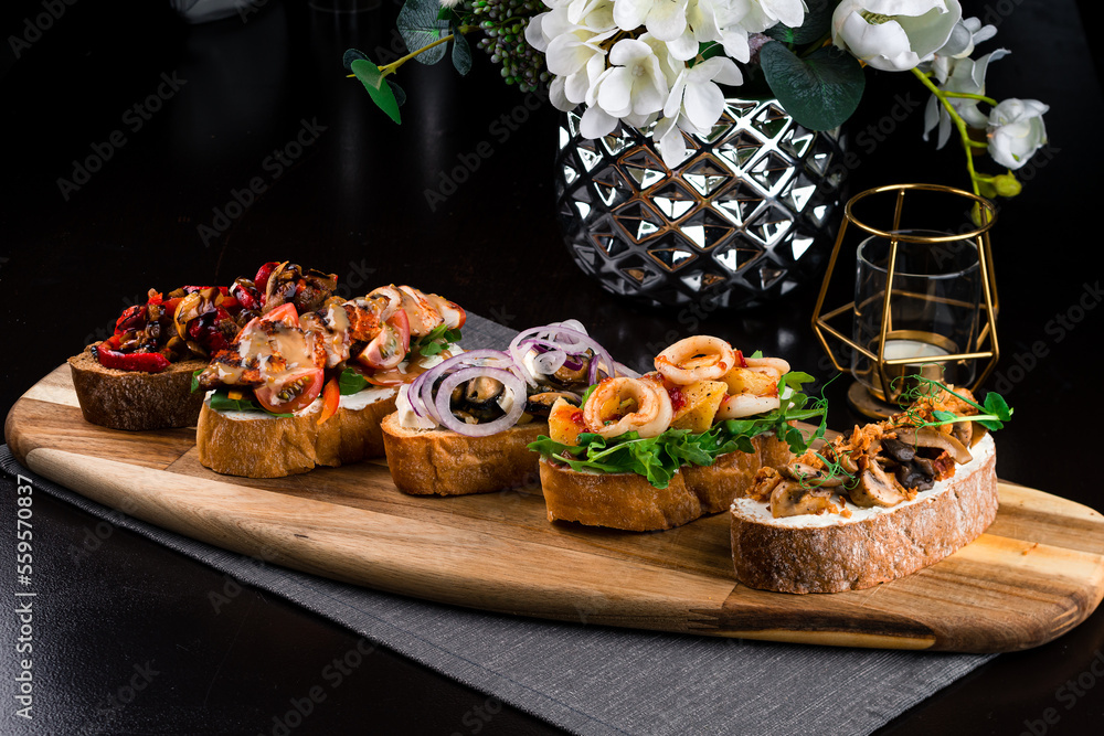 Canvas Prints Set Italian snacks bruschetta with seafood, meat and vegetables on a wooden board.