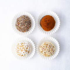Assorted vegan sweets, Delicious Candy Balls with seeds, dried fruit and cocoa powder, Healthy Candies