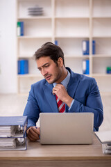 Young male employee working in the office