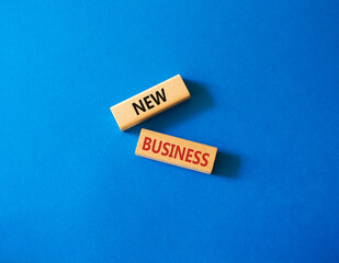 New business symbol. Concept words New business on wooden blocks. Beautiful blue background. Business and New business concept. Copy space.