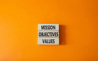 Mission Objectives Values symbol. Concept words Mission Objectives Values on wooden blocks. Beautiful orange background. Business and Mission Objectives Values concept. Copy space