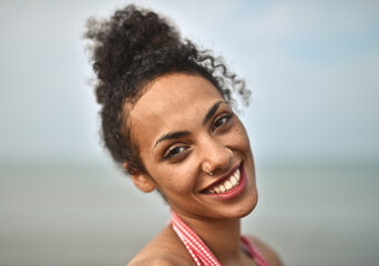 portrait of smiling young woman at the sea