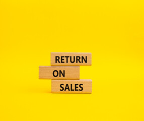 Return on Sales symbol. Concept word Return on Sales on wooden blocks. Beautiful yellow background. Business and Return on Sales concept. Copy space