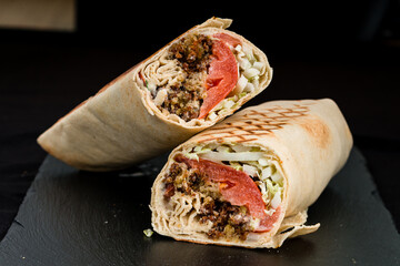 Shawarma from minced beef, tomatoes, lettuce, herbs, sauce and pita bread.