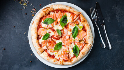 Pizza with shrimp, salmon, mozzarella, tomato sauce, basil on a thick dough with spices.