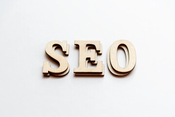 SEO letter tile initials which stand for Search Engine Optimization close up on white background.
