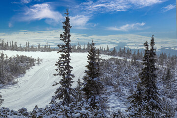 Ski track on  mountain top overlooking the valley.
