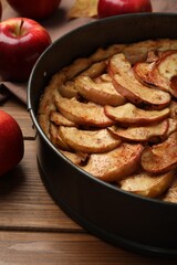 Delicious apple pie and fresh fruits on wooden table, closeup