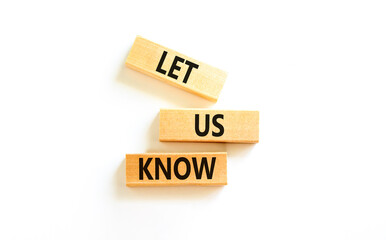 Let us know symbol. Concept words Let us know on wooden blocks on a beautiful white table white...