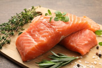 Fresh raw salmon and ingredients for marinade on wooden table, closeup