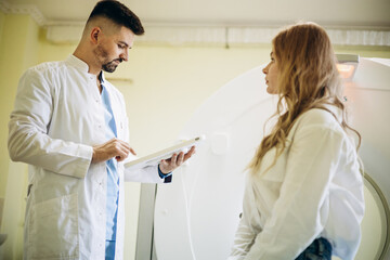 Fototapeta premium Man doctor with patient preparing before MRI scan