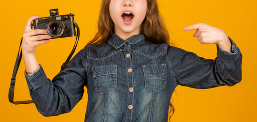 Surprised kid crop view pointing finger at camera yellow background, advert