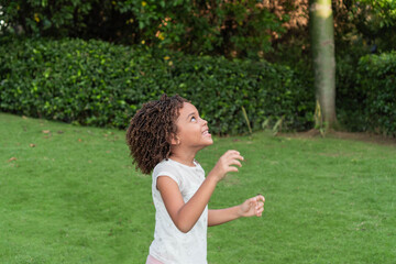 Afro-haired girl playing in the park
