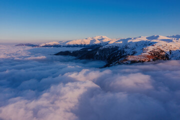 Caucasian mountains above the clouds at the sunset