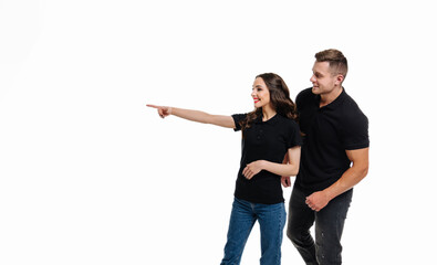 Cheerful emotional couple at isolated background. Young romantic couple posing on white.