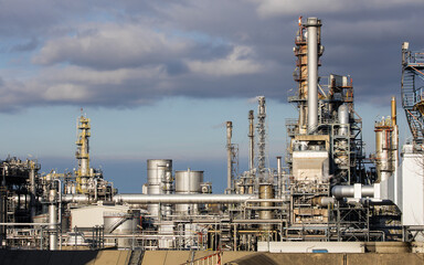 Industrial facility at a refinery with smokestacks for fuel production