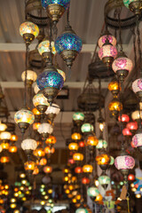 Row of traditional Turkish handmade lamps in a gift shop, colored glass mosaic