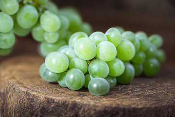 green grapes lie on a wooden table, generative AI