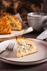 A piece of savory pie with chicken, potatoes and rice on a plate. Homemade pastries. Vertical view © elenarui
