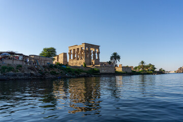 Fototapeta na wymiar Small temple next to the Philae temple, seen from the Nile river on a sunny day.