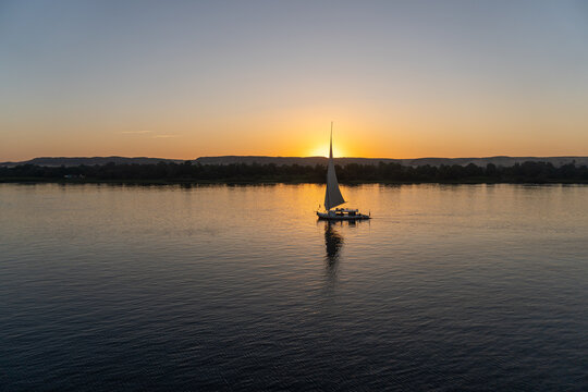 Typical Egyptian boat, navigating the Nile River at sunset.