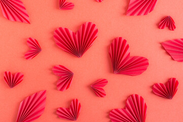 Monochrome red background with origami hearts and leaves. Eco friendly decor