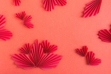 Postcard with origami leaves and hearts. Red monochrome background.