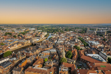 Fototapeta na wymiar The drone aerial view of York at sunrise, England. York is a cathedral city with Roman origins, sited at the confluence of the rivers Ouse and Foss in North Yorkshire, England.