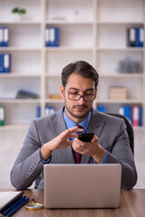 Young male employee working in the office