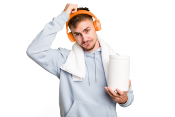 Young fitness man listening to music and holding a protein bottle isolated cut out being shocked, she has remembered important meeting.