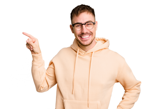 Young caucasian man cut out isolated smiling cheerfully pointing with forefinger away.