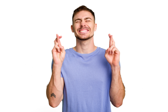 Young caucasian man cut out isolated crossing fingers for having luck - Powered by Adobe
