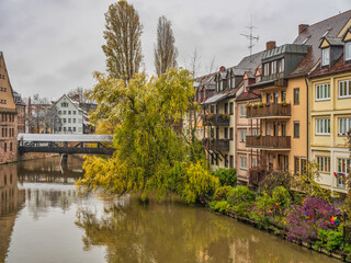 Fototapeta na wymiar Beautiful historic buildings and Hangman's Bridge on Pegnitz river in Nuremberg, Germany